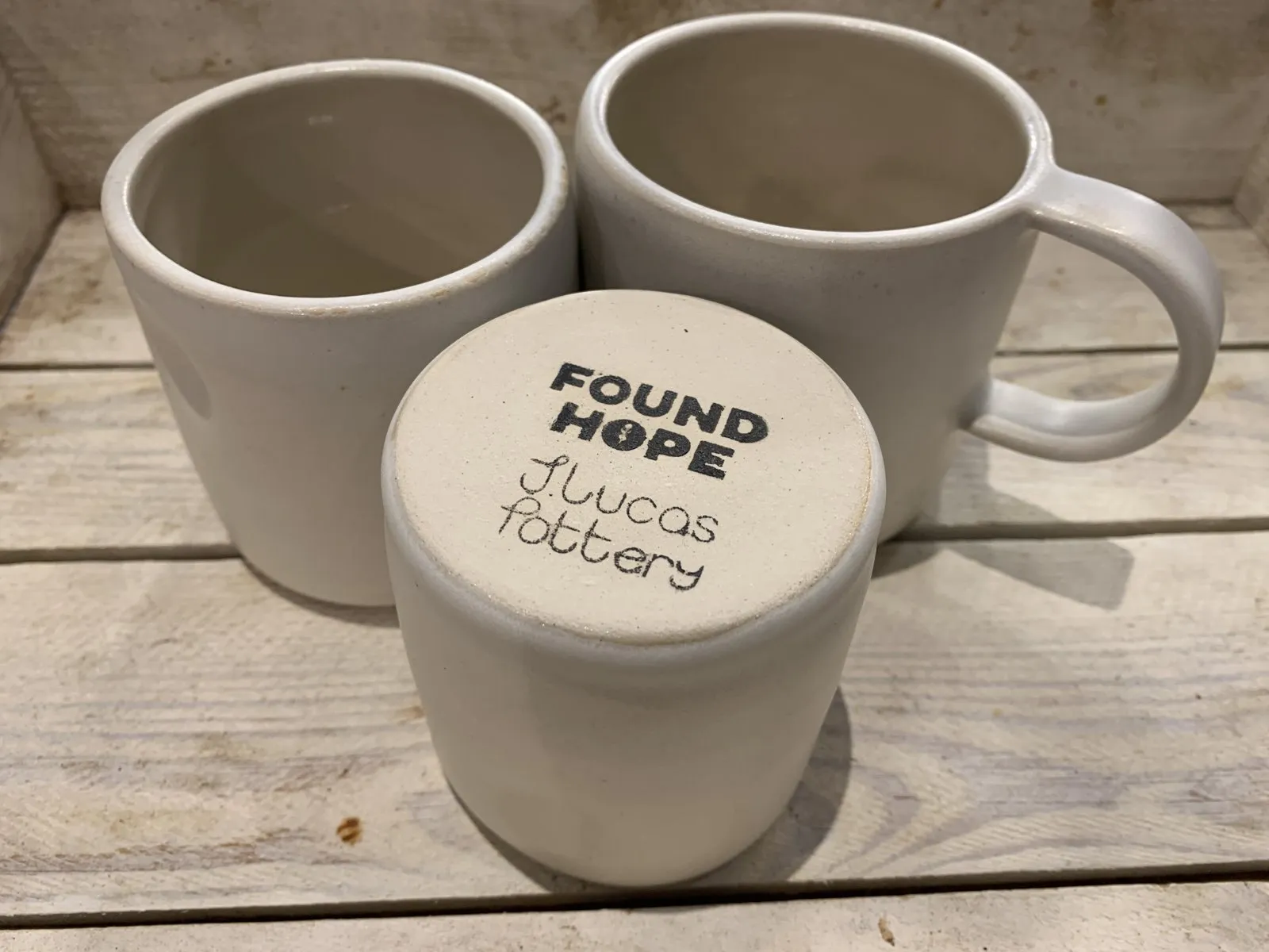 The base of a cup, stamped Found Hope and J Lucas Pottery