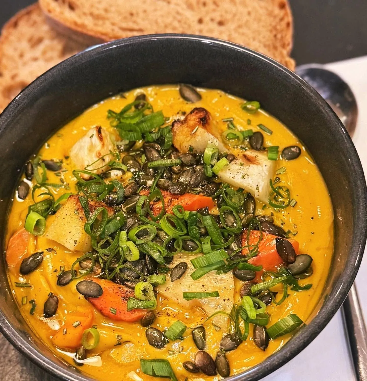 Squash soup with pumpkin seeds and sourdough